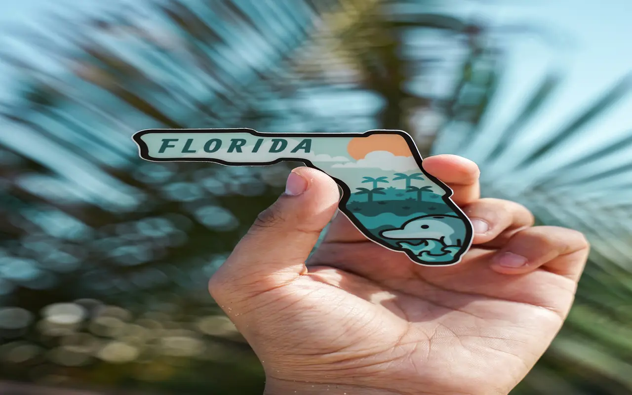 Hand holding a replica of Florida.